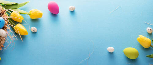 Easter Eggs And Flowers On A Blue Background