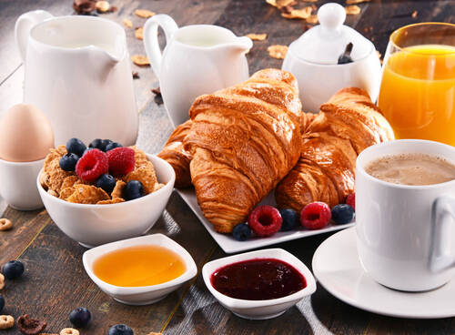 Breakfast served with coffee, juice, croissants and fruits