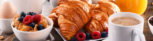 Breakfast served with coffee, juice, croissants and fruits